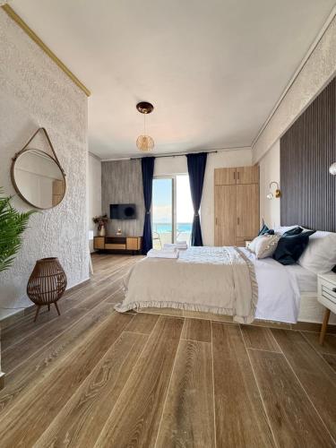 a bedroom with a large bed and a television at Beachfront Studio with Panoramic Sea View 2 in Ialysos