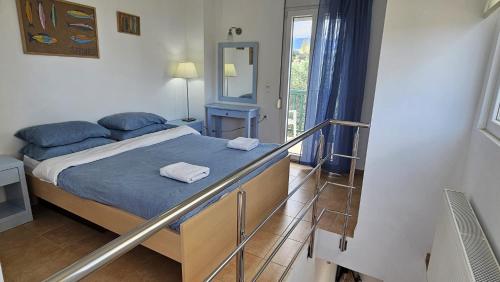 a small bedroom with a bed and a balcony at Myrtos Hidden Garden Villa in Ierapetra