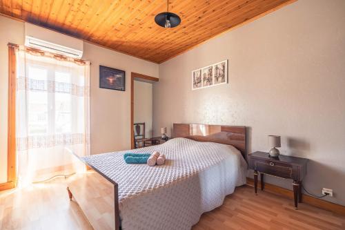 a bedroom with a bed with a teddy bear on it at Chez Catherine Et Gérard in Tonnay-Charente