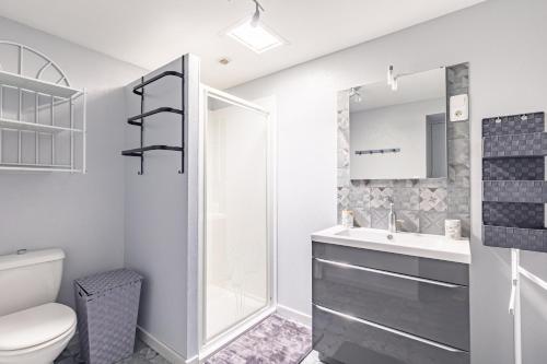 a white bathroom with a toilet and a sink at Chez Catherine Et Gérard in Tonnay-Charente
