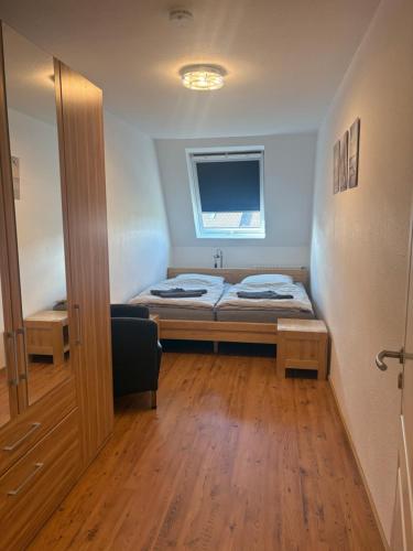 a small room with a bed and a window at Ferienwohnung Fortuna in Borkum