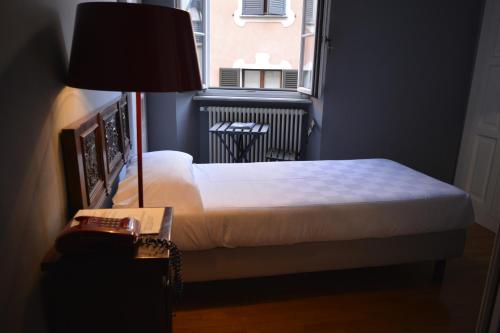 a bedroom with a bed and a window at Albergo Bologna in Varese
