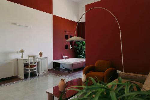 a living room with red walls and a couch at Villa Gloria in Monteroni di Lecce