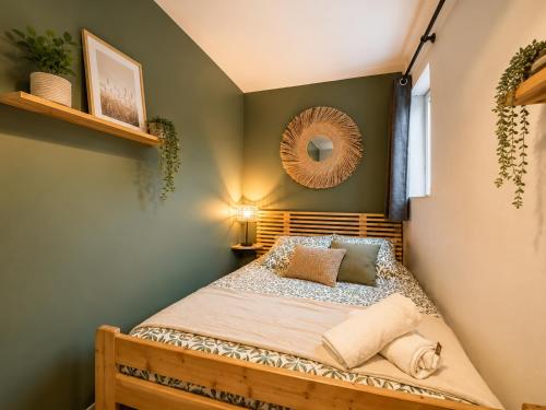 a bedroom with a bed with a mirror on the wall at Villaloha - Appartement avec terrasse in Bray-Dunes