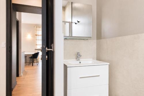 a bathroom with a sink and a mirror at F2 balcon à 1minute de la plage in Saint-Raphaël