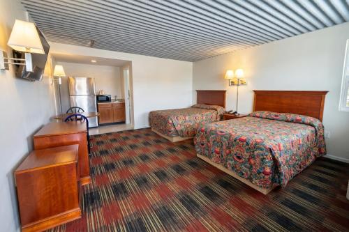 a hotel room with two beds and a kitchen at Carolina Inn Anderson Clemson Area in Anderson