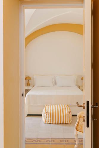 a bedroom with a white bed and a chair at Villa Gloria in Monteroni di Lecce