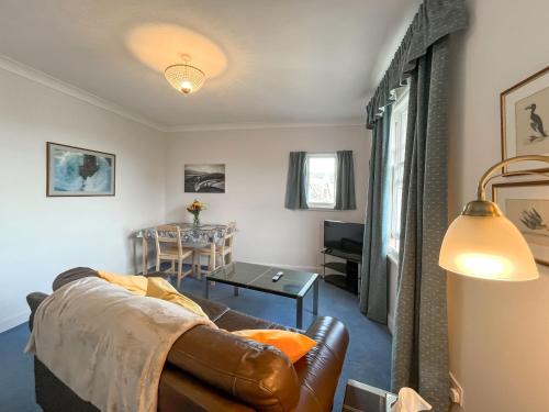 a living room with a couch and a table at Avocet Apartment - Uk51130 in Carradale