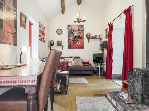 a living room with a table and a couch at Silk Hill Stables in Whaley Bridge