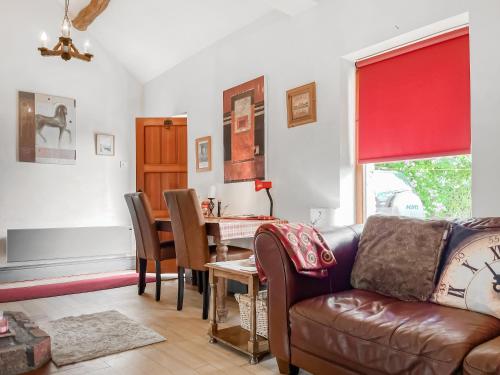a living room with a couch and a table at Silk Hill Stables in Whaley Bridge