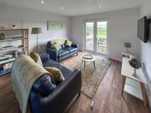 a living room with a couch and a table at Fern Lodge - Uk51604 in Peel