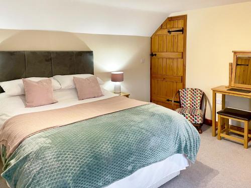 a bedroom with a large bed and a desk at Herrock View in Evenjobb