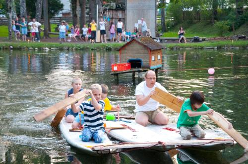 a group of people sitting on a raft in the water at Kinderhotel Appelhof in Mürzsteg