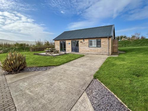 a house with a pathway leading into a yard at Primrose Lodge - Uk51602 in Peel