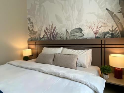 a bedroom with a large white bed with two lamps at Nuo Taksim Rooms in Istanbul