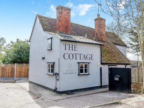 a white building with a sign on it at The Cottage in Broomfield