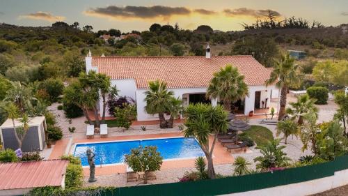 an aerial view of a house with a swimming pool at Quinta das Amendoeiras B&B in Nora