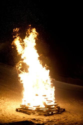 a fire burning in the street at night at Kinderhotel Appelhof in Mürzsteg