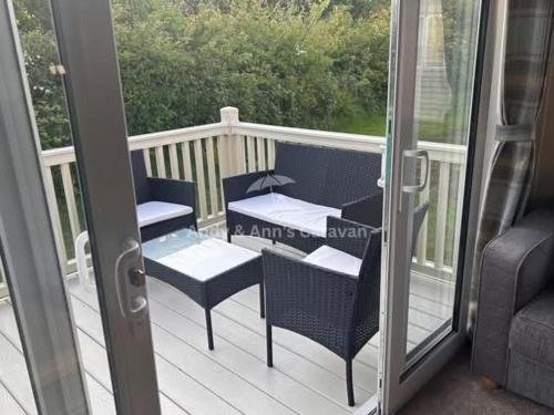 a patio with two chairs and a table on a balcony at 273 Northfield in Skipsea