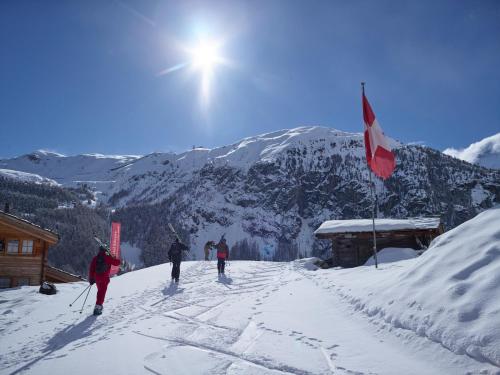 a group of people on skis in the snow at Chalet Nunavut, Ski in - Ski out with Complimentary Spa Access in Zermatt