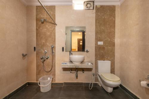 a bathroom with a toilet and a sink and a shower at ABI RESIDENCY Hitech City in Hyderabad