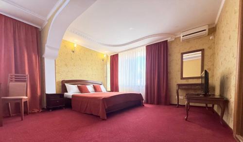 a hotel room with a bed and a television at Tourist Poltava in Poltava