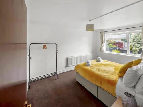 a bedroom with a bed and a window and a mirror at Modern 2 BR ground floor apartment with parking and garden in Belvedere
