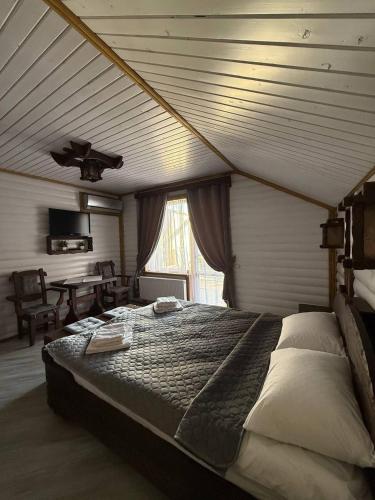 a bedroom with a large bed in a room at Ватрич House in Chernivtsi