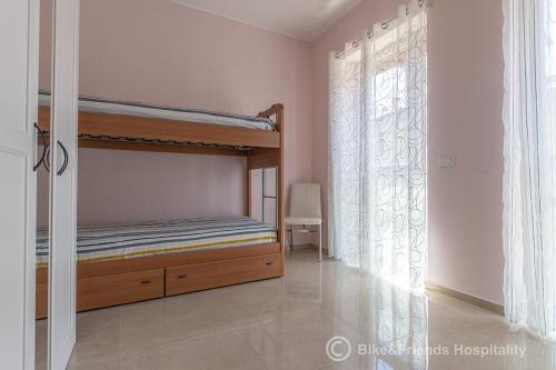 a bedroom with a bunk bed and a window at Dimora San Francesco in Pesaro