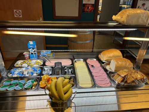 a buffet line with different types of bread and bananas at Gîte-Auberge Kaleo de Wanne in Trois-Ponts