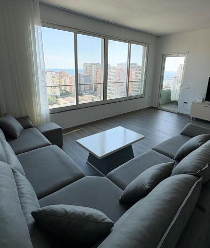 a living room with a couch and a table at Sea View Apartments in Durrës
