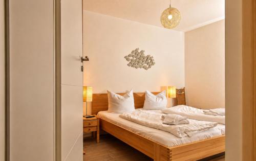 a bedroom with two beds with white sheets at Ferienhaus Alisch Fewo 3 in Warnemünde