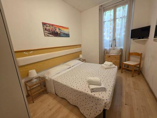a small bedroom with a bed and a window at Villa Cristina in Rapallo