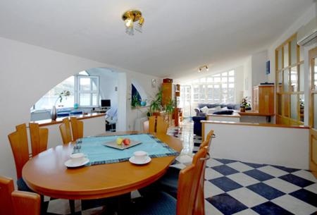 a dining room and kitchen with a table and chairs at Aparthotel Marina in Primošten