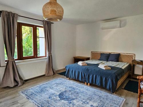 a bedroom with a bed and a large window at Kapolcsi Kuckó in Kapolcs