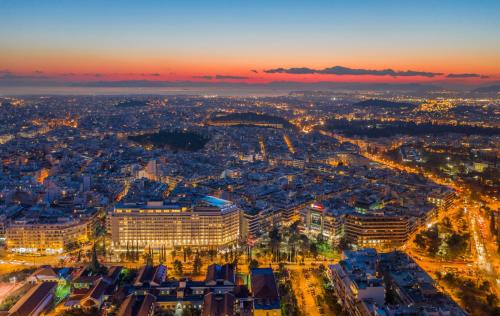 an aerial view of a city at night at Divani Caravel in Athens