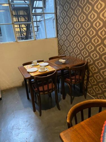 a dining room with wooden tables and chairs at Balcones de Cabrera in Buenos Aires