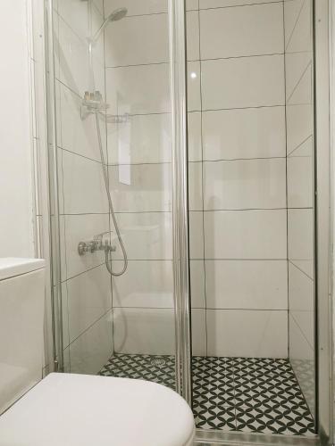 a shower with a glass door and a toilet at Nuo Taksim Rooms in Istanbul