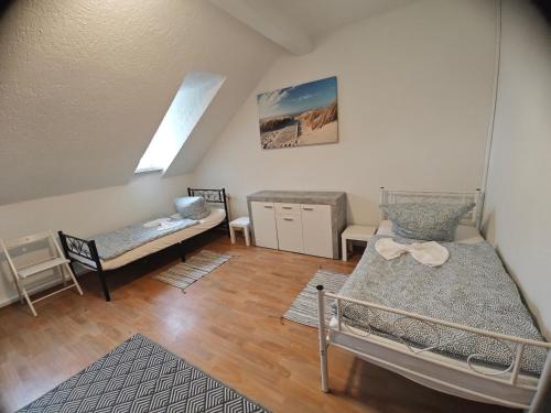 a room with two beds and a table and chairs at Revant Monteurzimmer Haus in Arnstadt