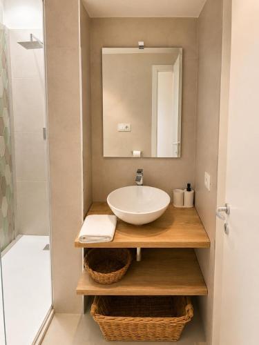 a bathroom with a sink and a mirror at Villasimius Il patio sul porto in Villasimius