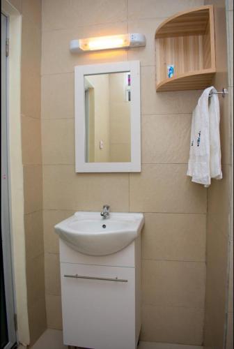 a bathroom with a sink and a mirror at Hillpark Hotel in Eldoret
