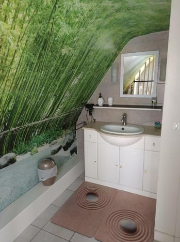 a bathroom with a sink and a fish tank at La Coccinelle Des Caps in Ambleteuse