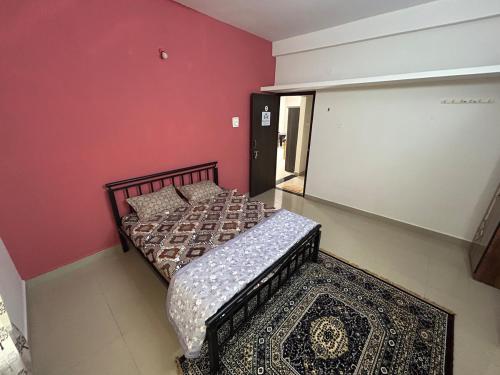a bedroom with two beds and a rug at RoyalNest Gardenia in Belgaum