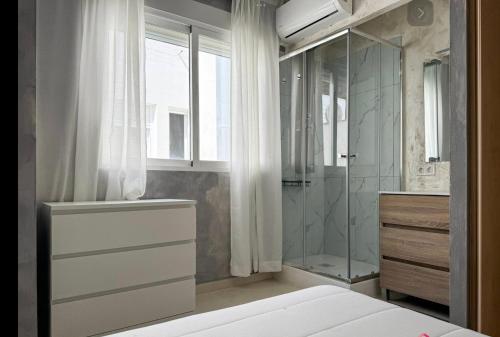 a bathroom with a glass shower and a sink at Pasarla rico in Torreblanca