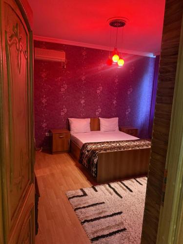 a bedroom with a bed with a red ceiling at Gabala mountain house in Gabala