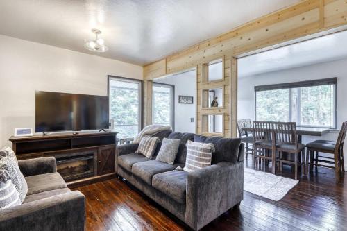 a living room with a couch and a flat screen tv at Orion Ridge Retreat in Stateline
