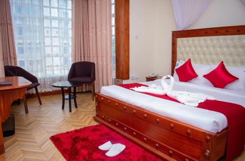 a hotel room with a bed with white towels on it at Hillpark Hotel in Eldoret