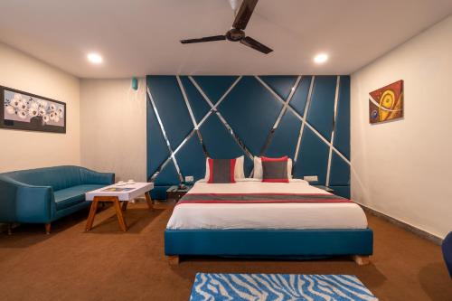 a bedroom with a bed and a blue wall at ABI RESIDENCY Hitech City in Hyderabad