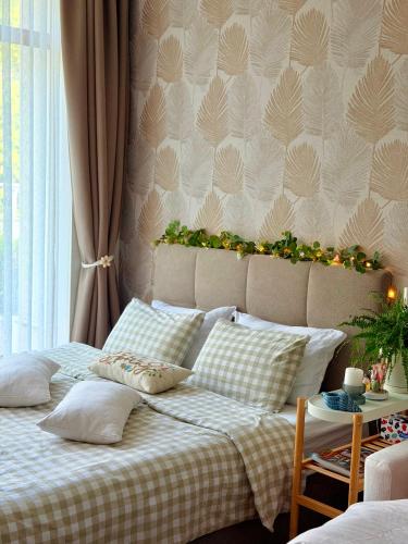 a bedroom with a bed with pillows on it at Coral Bay Studio Varna - Beachfront with Free Parking in Varna City