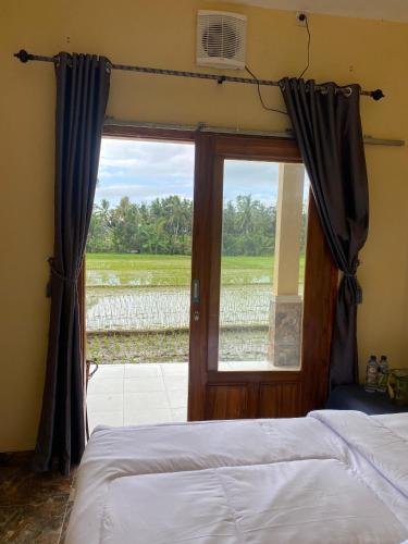 a bedroom with a bed and a door with a window at Sabin view homestay in Licin